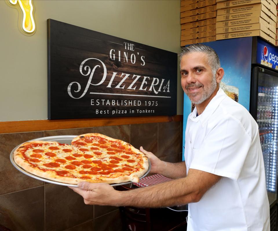 Joe Porco, owner of Gino's Pizzeria on South Broadway in Yonkers, shows off his heart shaped pizza at the shop, Feb. 1, 2023. 