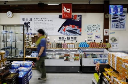 A visitor walks past a whale products corner at a roadside store named WA-O! in Minamiboso