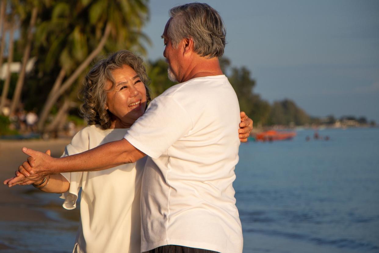Senior couple dancing on beach.elderly travel leisure and activity after retirement in vacations and summer