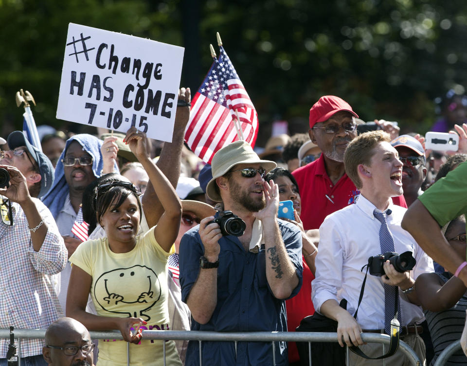 People cheer as an honor guard from the South Carolina Highway patrol removes the Confederate battle flag from the Capitol grounds Friday, July 10, 2015, in Columbia, S.C. 