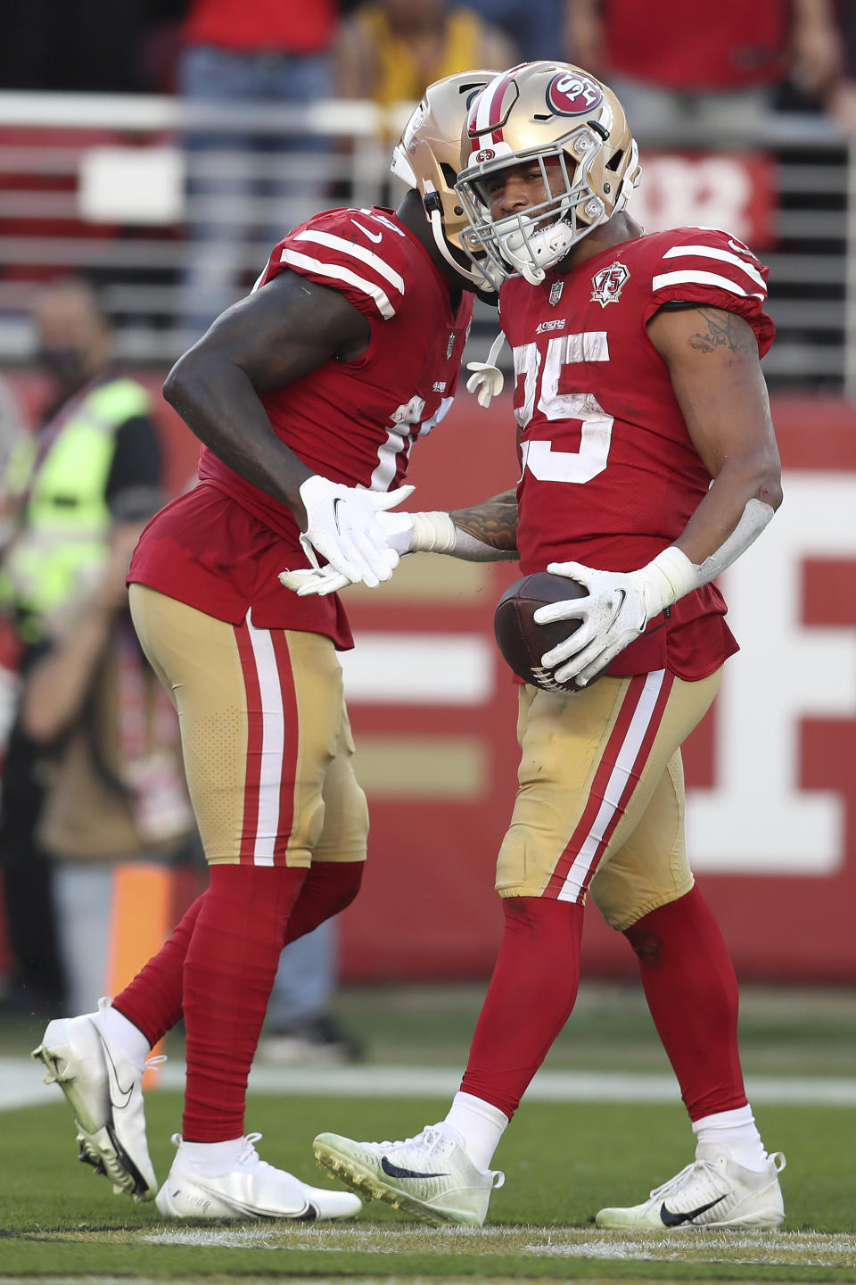San Francisco 49ers running back Elijah Mitchell (25) is congratulated by wide receiver Deebo Samuel after scoring against the Minnesota Vikings during the second half of an NFL football game in Santa Clara, Calif., Sunday, Nov. 28, 2021. (AP Photo/Jed Jacobsohn)