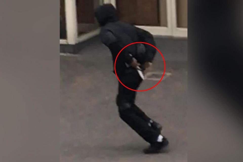 The man flees while attempting to conceal a knife after a stabbing