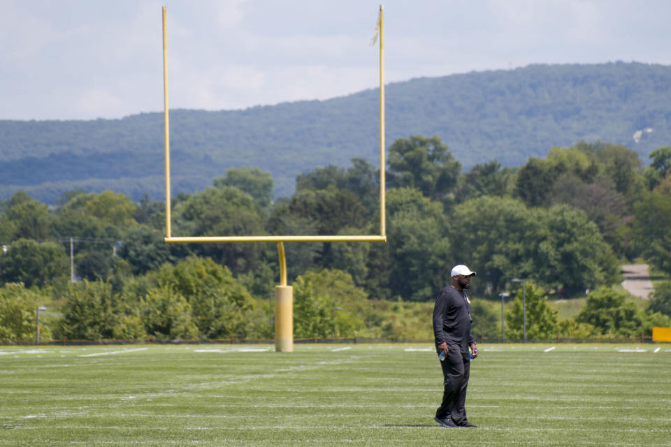 Pittsburgh Steelers head coach Mike Tomlin walks in front of a goal post on one of the practice fields on the first day of drills at their NFL football training camp practice in Latrobe, Pa., Friday, July 26, 2019. (AP Photo/Keith Srakocic)