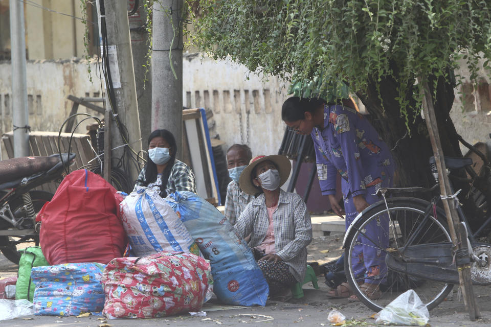 State railway employees sit with their belongings after being evicted from their home Saturday, March 20, 2021, in Mandalay, Myanmar. State railway workers in Mandalay have been threatened with eviction to force them to end their support for the Civil Disobedience Movement (CDM) against military rule. (AP Photo)