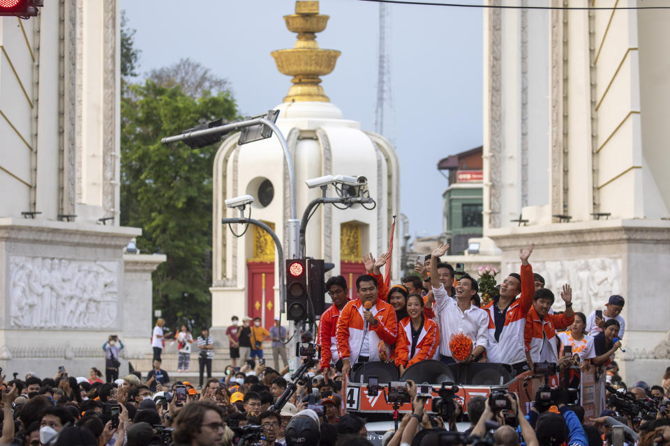 Pita Limjaroenrat, center, (white shirt) leader of Move Forward Party, waves to his supporters in Bangkok, Monday, May 15, 2023. Fresh off a stunning election victory in which they together captured a majority of seats in the House of Representatives, Thailand's top two opposition parties began planning Monday for the next stage in their bid to replace the military-dominated government. (AP Photo/Wason Wanichakorn)