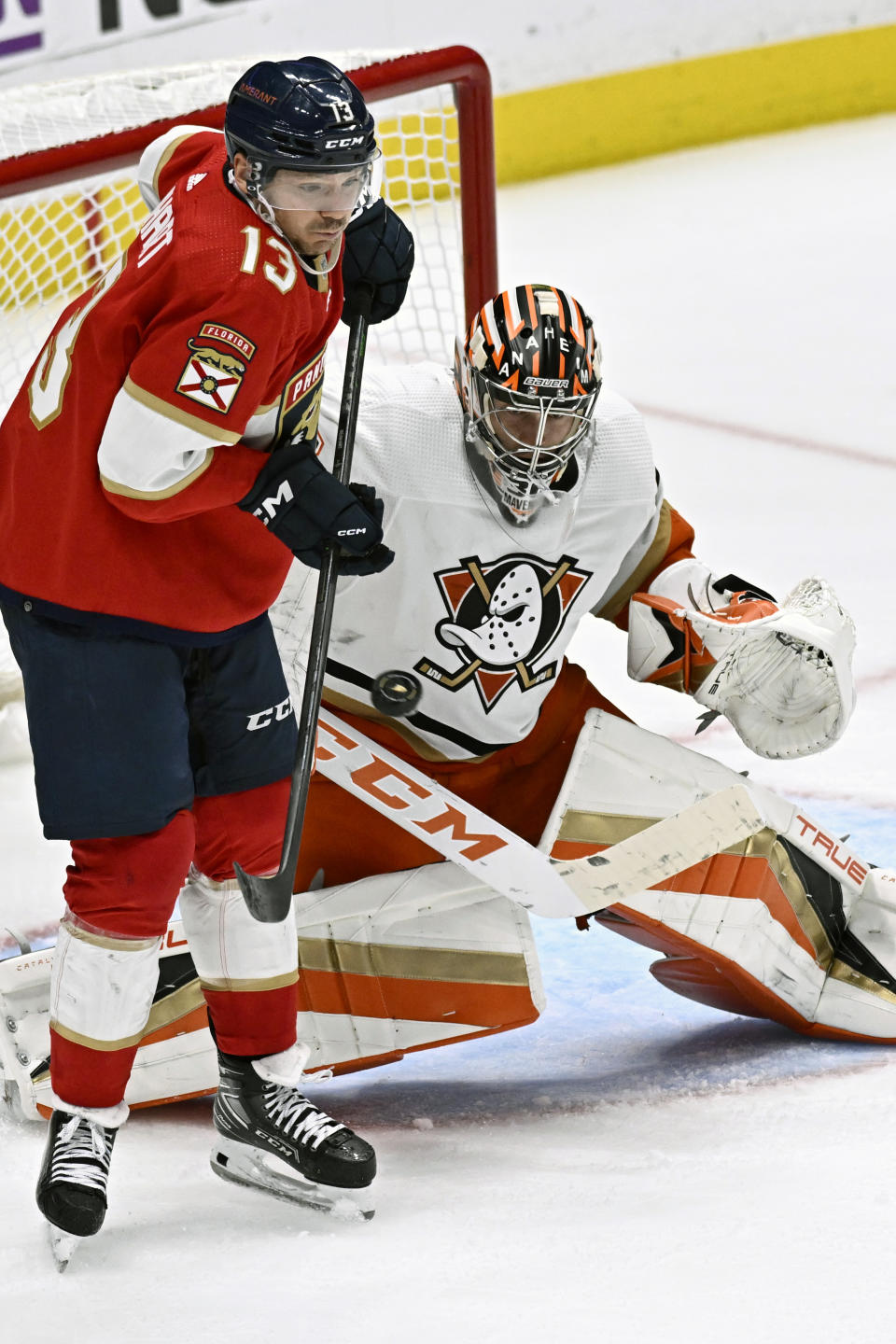 Florida Panthers center Sam Reinhart, left, attempts to redirect the puck against Anaheim Ducks goaltender John Gibson during the third period of an NHL hockey game in Anaheim, Calif., Sunday, Nov. 6, 2022. (AP Photo/Alex Gallardo)