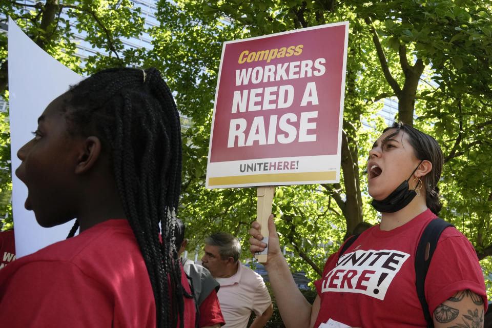 Workers who are contracted to feed World Bank employees through a firm called the Compass Group, protest for higher wages and affordable healthcare benefits, Wednesday, April 12, 2023, outside of the World Bank in Washington. (AP Photo/Mariam Zuhaib)