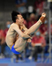 Xie Siyi of China competes in men's diving 3m springboard semifinal at the Tokyo Aquatics Centre at the 2020 Summer Olympics, Tuesday, Aug. 3, 2021, in Tokyo, Japan. (AP Photo/Dmitri Lovetsky)