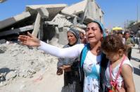 Relatives mourn during the funeral of two Syrian toddlers who drowned with their mother as they were trying to reach Greece, at the Syrian border town of Kobani September 4, 2015. The toddlers, including three-year-old Aylan Kurdi, were laid to rest in the Syrian town of Kobani on Friday, a Reuters witness said. Abdullah Kurdi, their father, wept as their bodies were buried alongside each other in the "Martyrs' Ceremony" in the predominantly Kurdish town of Kobani, also known as Ayn al-Arab, near at the border with Turkey. REUTERS/Rodi Said