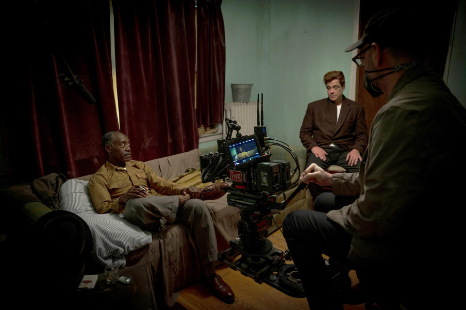 This image released by Warner Bros. Entertainment shows director Steven Soderbergh, right, with actors, Don Cheadle, left, and Benicio Del Toro, right, on the set of "No Sudden Move." (Claudette Barius/Warner Bros. Entertainment via AP)