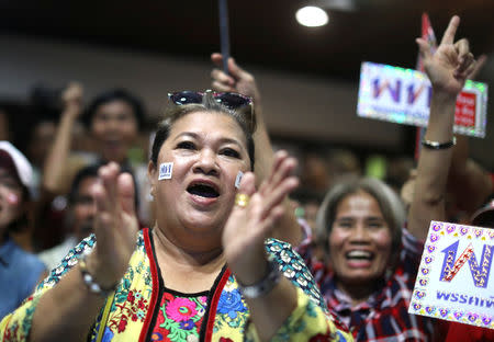 Supporters of Pheu Thai Party react after unofficial results, during the general election in Bangkok, Thailand, March 24, 2019. REUTERS/Athit Perawongmetha