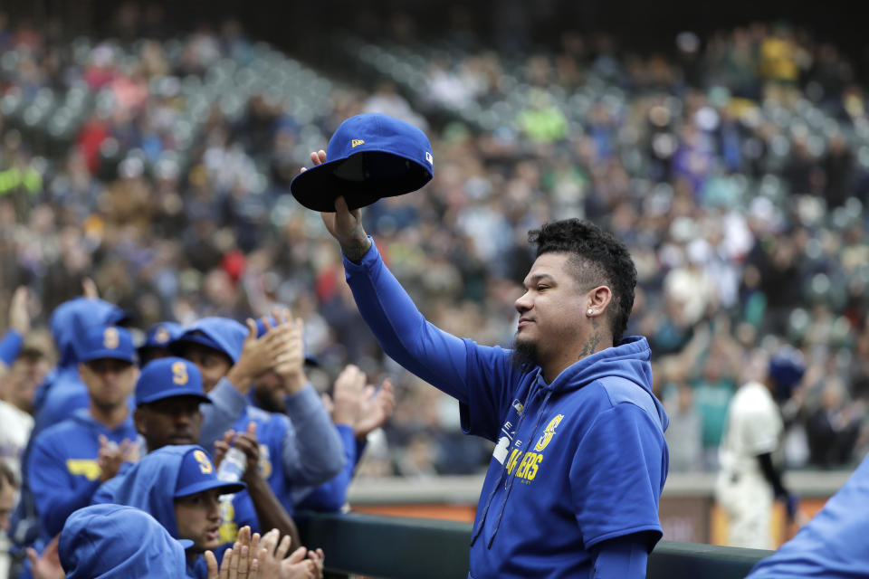 Seattle Mariners pitcher Felix Hernandez, who made his last start days earlier, waves to fans from the dugout between innings of a baseball game against the Oakland Athletics Sunday, Sept. 29, 2019, in Seattle. (AP Photo/Elaine Thompson)