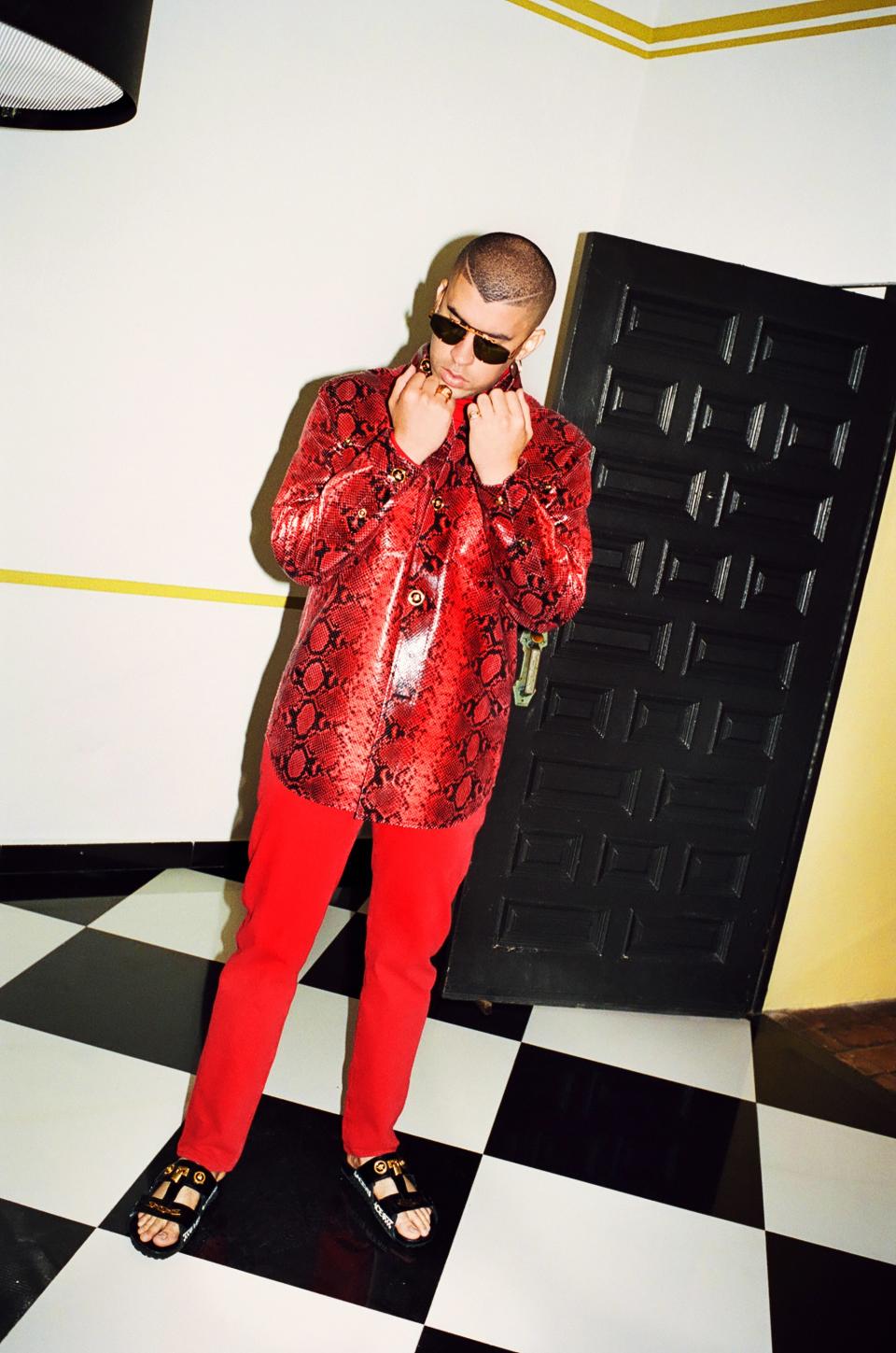 Shirt, $7,595, sandals, $1,475, ring (on right hand), $375, by Versace / Turtleneck, $495, by Roberto Cavalli / Pants, $60, by Levi's / Sunglasses, $895, by Jacques Marie Mage / Ring (on left hand), $1,795, by John Hardy