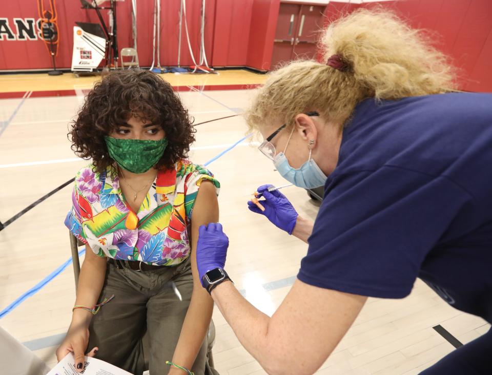 Nyack High School student Emma Dorpe gets a COVID-19 vaccine shot from Nyack Hospital Nurse Dori Barret at the high school May 19, 2021.