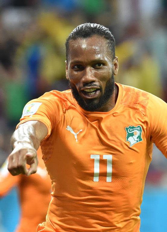 Ivory Coast's captain Didier Drogba celebrates after Gervinho scores a goal during their Group C match against Japan, at the Pernambuco Arena in Recife, during the FIFA World Cup, on June 14, 2014