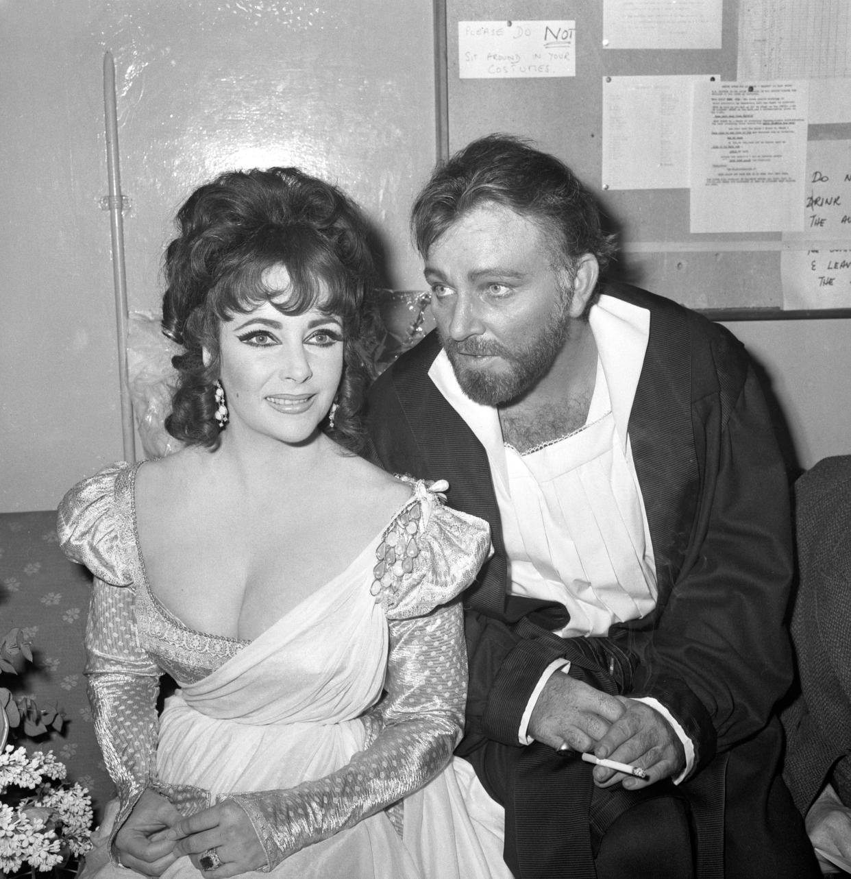 Elizabeth Taylor and Richard Burton after appearing in the first night of the Oxford University Dramatic Society production of Marlowe's Dr Faustus at the Playhouse Theatre. Mr Burton played the title role and wife played the non-speaking part of Helen of Troy. When the play ended last night, the cast took 15 curtain calls and enjoyed over nine minutes of applause.