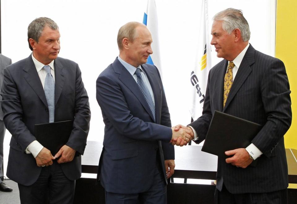 Russian President Vladimir Putin and Exxon Mobil CEO Rex Tillerson shake hands at a signing ceremony of an agreement between state-controlled Russian oil company Rosneft and Exxon Mobil corporation at the Black Sea port of Tuapse, southern Russia, Friday, June 15, 2012. At left is CEO of state-controlled Russian oil company Rosneft Igor Sechin. (AP Photo/RIA-Novosti, Mikhail Klimentyev, Presidential Press Service)