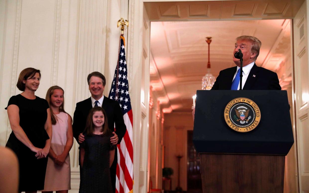 Mr Trump introduces Brett Kavanaugh and his family in the White House East Room - REUTERS