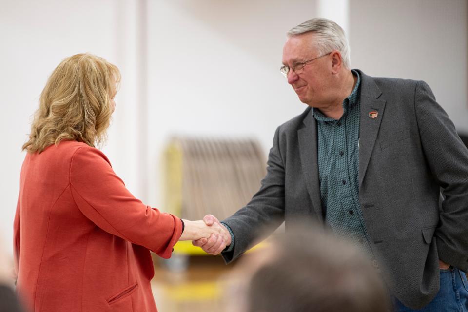 Polk County commissioner candidates Roxanne Beltz and Lyle Mordhorst shake hands at the Polk County Fairgrounds.