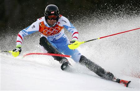 Austria's Mario Matt clears a gate during the first run of the men's alpine skiing slalom event at the 2014 Sochi Winter Olympics at the Rosa Khutor Alpine Center February 22, 2014. REUTERS/Dominic Ebenbichler