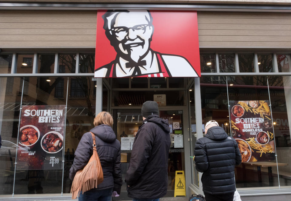 People look into a closed KFC restaurant&nbsp;in Bristol, England, on Tuesday. (Photo: Matt Cardy via Getty Images)