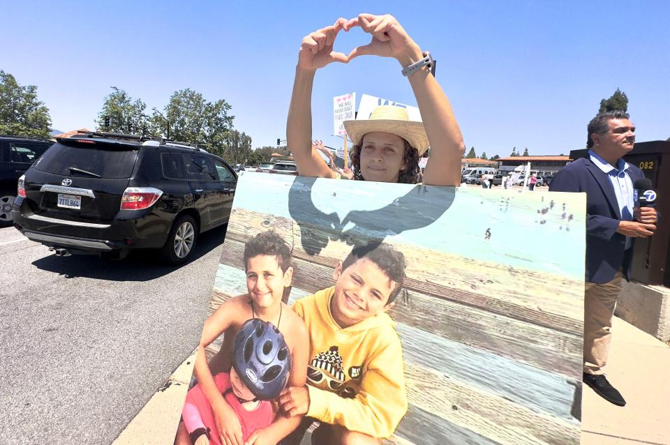 Miriam Guirguis, aunt of Mark and Jacob Iskander, attends the "stand up for victims” event at the corner of Westlake and Thousand Oaks Blvd in June.