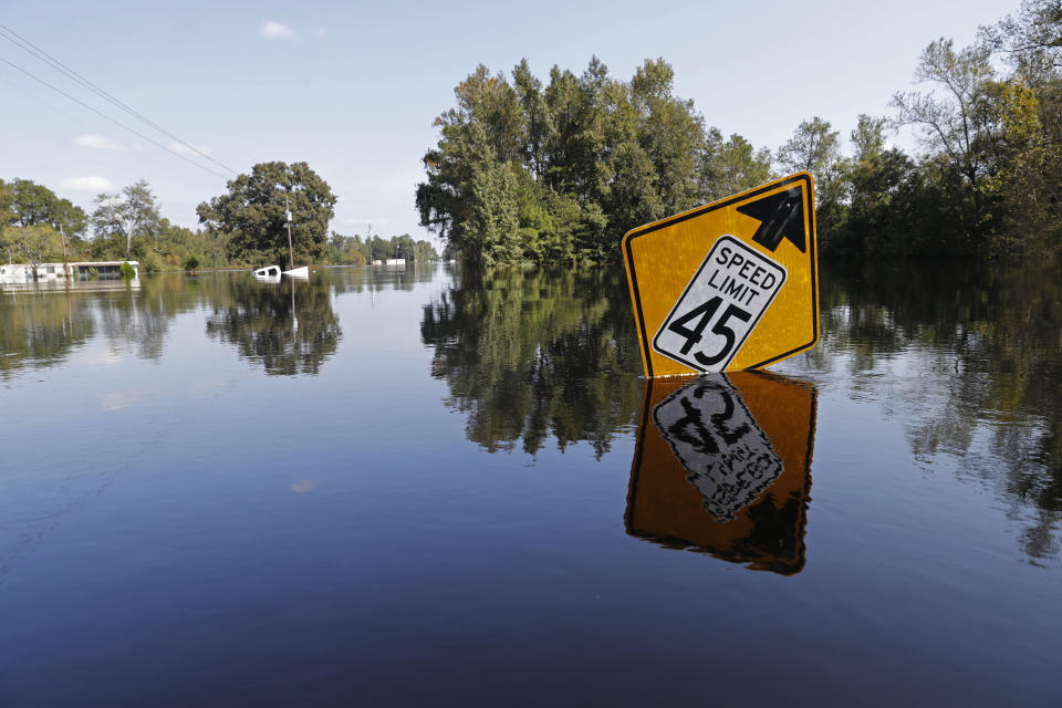 A street sign sticks up from floodwaters in the aftermath of Hurricane Florence in Nichols, S.C., Friday, Sept. 21, 2018. Virtually the entire town is flooded and inaccessible except by boat, just two years after it was flooded by Hurricane Matthew. (AP Photo/Gerald Herbert)