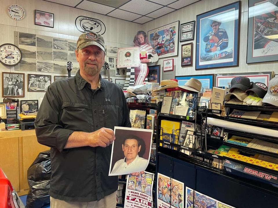 Mike Staley holds a photo of his father and late longtime owner of North Wilkesboro Speedway, Enoch Staley, in his house ahead of the NASCAR All-Star Race on Sunday, May 21, 2023.