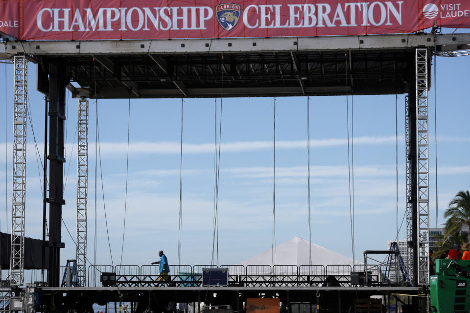 A worker walks across a temporary stage set up in preparation for the Florida Panthers Stanley Cup Celebration on Fort Lauderdale Beach on Friday, June 28, 2024. (Amy Beth Bennett /South Florida Sun-Sentinel via AP)