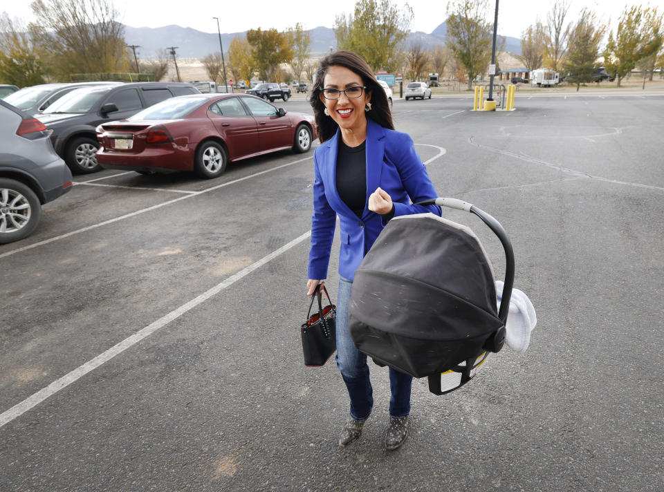 Rep. Lauren Boebert, R-Colo., walks into the Ute Mountain Casino Hotel carrying her 6-month-old grandson, Josiah Boebert, Saturday, Oct. 28, 2023, in Towaoc, Colo., before speaking at the Montezuma County Lincoln Day Dinner. (AP Photo/Jerry McBride)