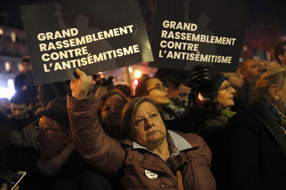 People gather at the Republique square to protest against anti-Semitism, in Paris, France, Tuesday, Feb. 19, 2019. In Paris and dozens of other French cities, ordinary citizens and officials across the political spectrum geared up Tuesday to march and rally against anti-Semitism, following a series of anti-Semitic acts that shocked the nation. (AP Photo/Christophe Ena)