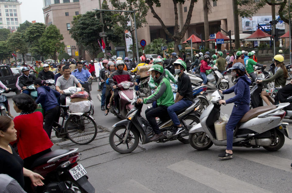 Vehicles starts to move after roads reopened following the motorcade of North Korean leader Kim Jong Un was driven off Melia hotel in Hanoi, Vietnam, Saturday, March 2, 2019. (AP Photo/Gemunu Amarasinghe)