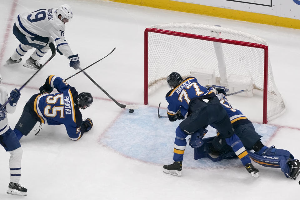 Toronto Maple Leafs' Calle Jarnkrok (19) scores past St. Louis Blues' Colton Parayko (55) and Niko Mikkola (77) during the second period of an NHL hockey game Tuesday, Dec. 27, 2022, in St. Louis. (AP Photo/Jeff Roberson)