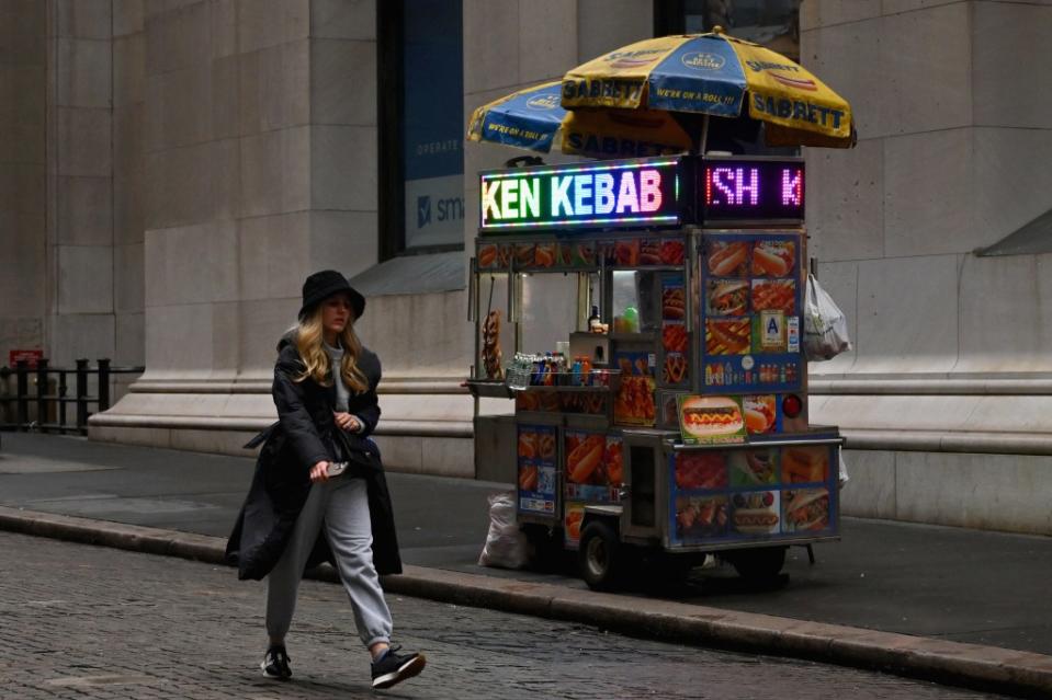 Halal food carts line New York City streets, promoting their burgers, kebabs and other eats on scrolling LED sign displays. AFP via Getty Images