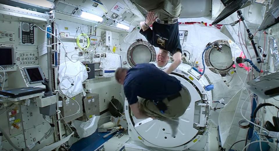 British astronaut Tim Peake performs dozens of somersaults aboard the International Space Station with the help of NASA astronaut Tim Kopra (background).
