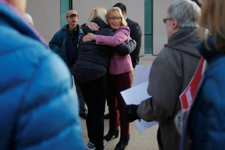 U.S. Senator Maggie Hassan (D-NH) (R) hugs demonstrators holding an "Interfaith Prayer Vigil for Immigrant Justice" outside the federal building, where ethnic Chinese Christians who fled Indonesia after wide scale rioting decades ago and overstayed their visas in the U.S. must check-in with ICE, in Manchester, New Hampshire, U.S., October 13, 2017. REUTERS/Brian Snyder