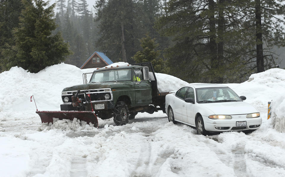 File - In this Feb. 28, 2019, file photo, snow, from recent storms, is cleared from the parking lot of the Strawberry Lodge at Strawberry, Calif. A cold front traveling down to Northern California from the Gulf of Alaska is expected to dump at least a foot of snow in higher elevations of the Sierra Nevada weeks before the start of summer. National Weather Service meteorologist Brendon Rubin-Oster says the first storm will arrive Wednesday, May 15, 2019, and will continue through Thursday. (AP Photo/Rich Pedroncelli, File)
