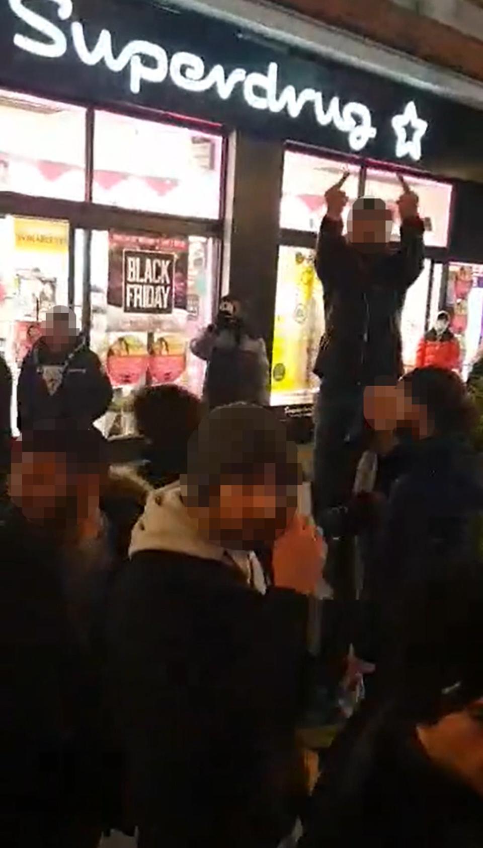 Men making obscene gestures towards a group of young Jewish people in Oxford Street (Joanne Orezi/PA) (PA Media)