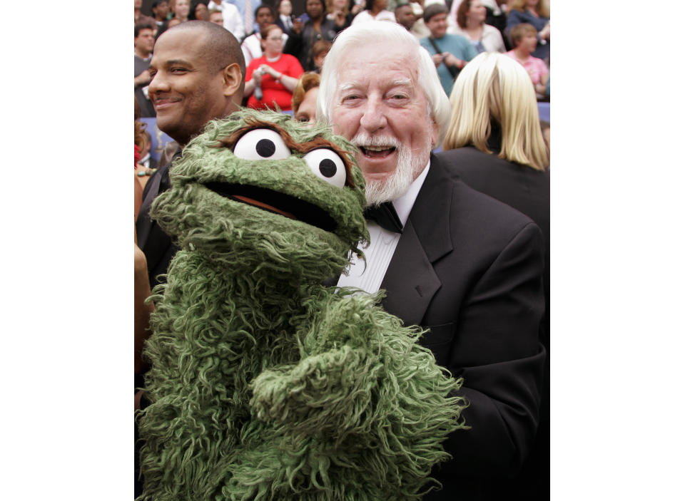 Caroll Spinney, the puppeteer who plays the roles of Big Bird and Oscar the Grouch on "Sesame Street," arrives holding the Oscar the Grouch puppet at the 33rd Annual Daytime Emmy Awards in Los Angeles on April 28, 2006. Spinney died on dec. 8. He was 85. (AP Photo/Reed Saxon)