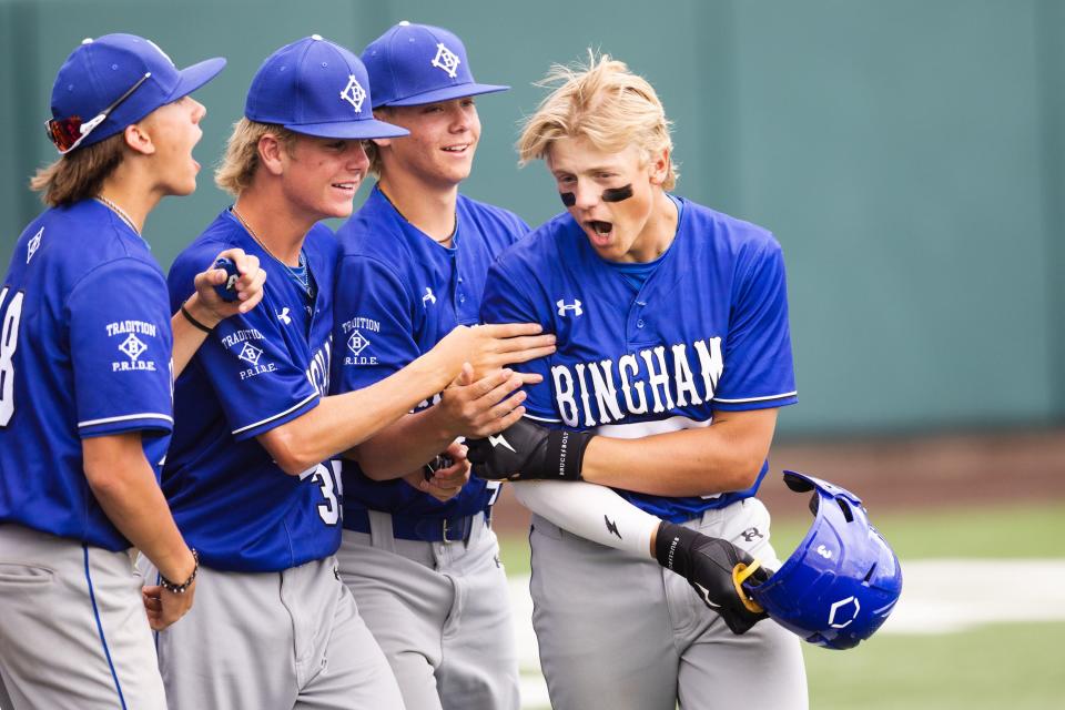 Bingham teammates congratulate Kameron <a class="link " href="https://sports.yahoo.com/ncaab/players/141566" data-i13n="sec:content-canvas;subsec:anchor_text;elm:context_link" data-ylk="slk:Beck;sec:content-canvas;subsec:anchor_text;elm:context_link;itc:0">Beck</a> after he scored a run during the 6A baseball state tournament game against Mountain Ridge at UCCU Ballpark in Orem on Monday, May 22, 2023. | Ryan Sun, Deseret News