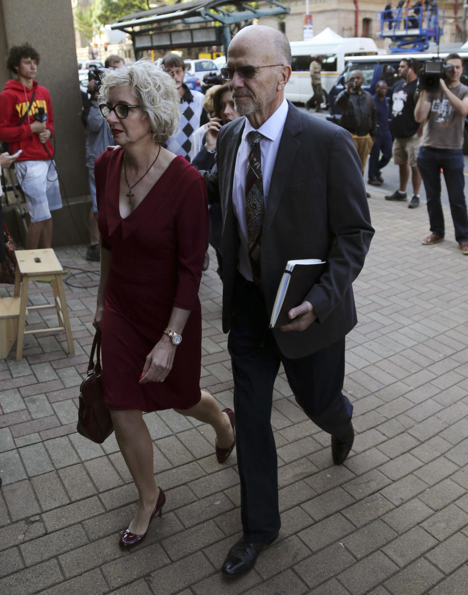 Oscar Pistorius's uncle Arnold Pistorius and his wife Lois arrive at the high court in Pretoria, South Africa, Tuesday, April 8, 2014. Oscar Pistorius, who is charged with murder for the shooting death of his girlfriend, Reeva Steenkamp, on Valentines Day in 2013, was testifying for a second day at his murder trial Tuesday, answering questions from his defense lawyer. (AP Photo/Themba Hadebe)