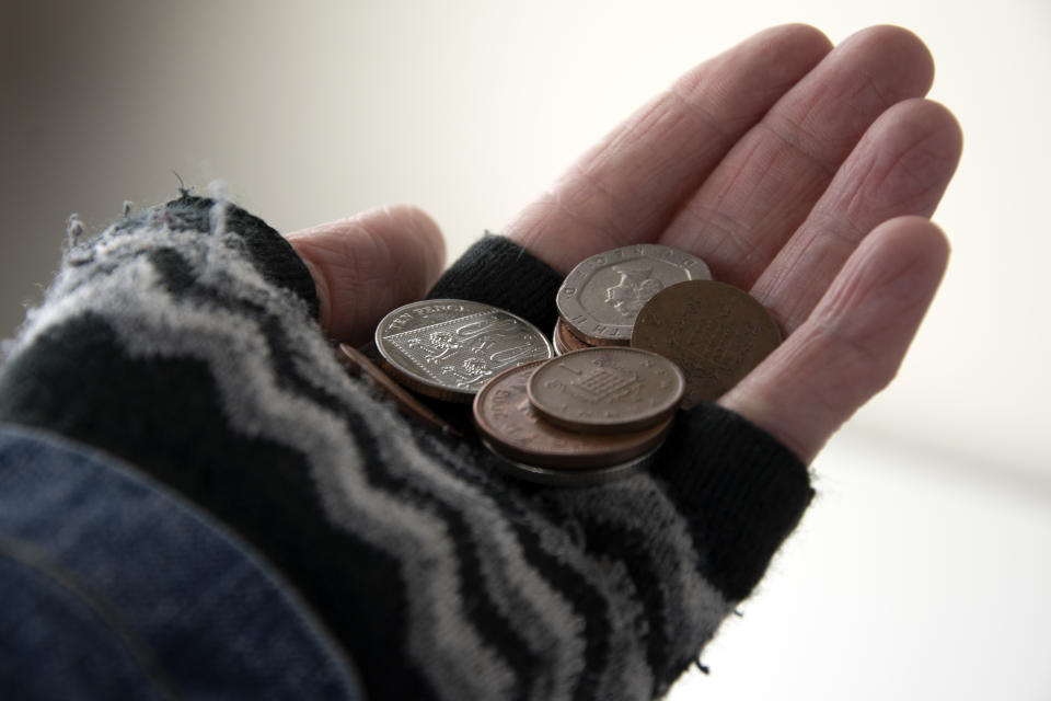 Collection of British coins in gloved hand