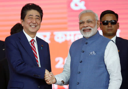 Japanese Prime Minister Shinzo Abe (L) shakes hands with his Indian counterpart Narendra Modi during the groundbreaking ceremony of a high-speed rail project in Ahmedabad, India, September 14, 2017. REUTERS/Amit Dave