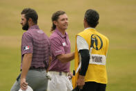 Cameron Smith, of Australia, centre, shakes hands with Cameron Young of the US, left, and his caddie after the final round of the British Open golf championship on the Old Course at St. Andrews, Scotland, Sunday July 17, 2022. (AP Photo/Gerald Herbert)