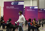 People wait in the observation area after receiving the Pfizer COVID-19 vaccine at the Vaccination Centre of Hope at the Cape Town International Convention Centre in Cape Town, South Africa, Tuesday, Nov. 30, 2021. (AP Photo/Nardus Engelbrecht)