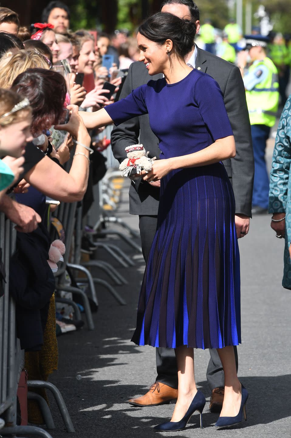 <p>For one of her final outfits of the royal tour, Meghan stepped out in a custom navy Givenchy look. The Duchess also wore a pair of pumps by Manolo Blahnik.</p><p><a class="link " href="https://www.barneys.com/product/manolo-blahnik-bb-pumps-503345489.html" rel="nofollow noopener" target="_blank" data-ylk="slk:SHOP NOW;elm:context_link;itc:0;sec:content-canvas">SHOP NOW</a> <em>Manolo Blahnik Pumps, $625</em></p>