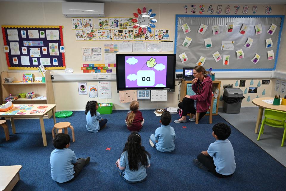 In a reception classroom, children sit apart from each other on a carpet where crosses have been marked out for them to sit on, in a teaching environment safe from Coronavirus for pupils and teachers at Brambles Primary Academy in Huddersfield, northern England on June 4, 2020, as the Government's recommencing of education for Reception and Years 1 and 6 classes gets underway. - Primary schools reopened the week commencing June 1, welcoming back children in Reception, year 1 and year 6 age groups, alongside priority groups. (Photo by Oli SCARFF / AFP) (Photo by OLI SCARFF/AFP via Getty Images)