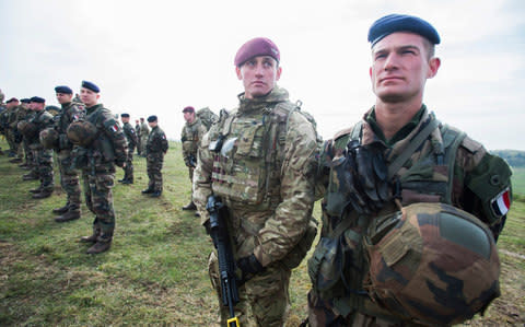 Exercise Griffin Strike, a joint military exercise between English and French forces, watched by the respective Defence Ministers of both countries. It is the largest joint exercise of the Combined Joint Expeditionary forces since the Suez Crisis. British Soldiers with their French counterparts during an inspection by Ministers. 21st April 2016 - Credit: David Rose