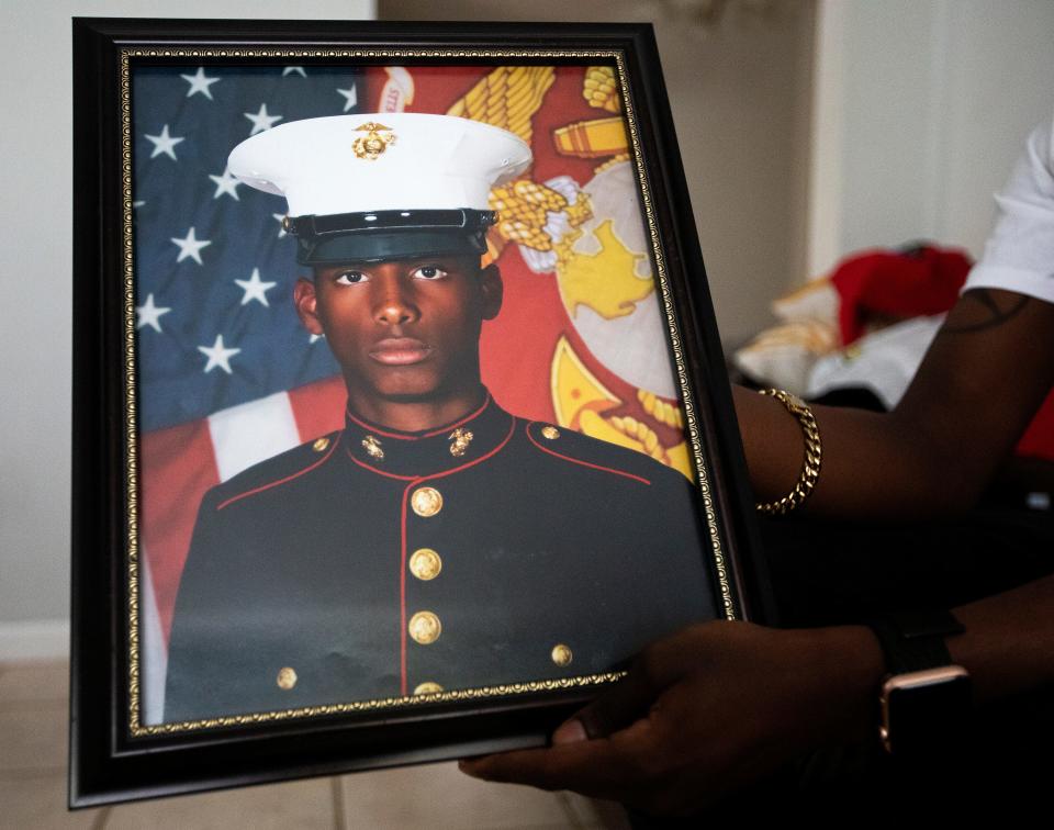 Jalen Richardson holds a photo on Tuesday, July 12, 2022 of his cousin Malique Richardson, a 24-year-old Marine who was killed last week in Tallahassee, Fla.