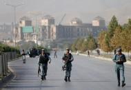 Afghan policemen walk after an attack at the American University of Afghanistan in Kabul, Afghanistan August 25, 2016. REUTERS/Mohammad Ismail